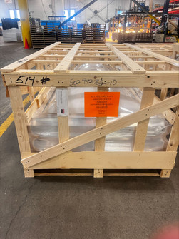 Wood-crated Velux shrink-out smoke vent staged in a warehouse for shipment