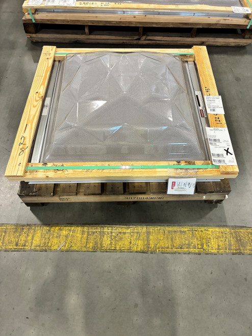 Velux CMD2 skylight dome crated in a wood shipping frame on a pallet inside a warehouse