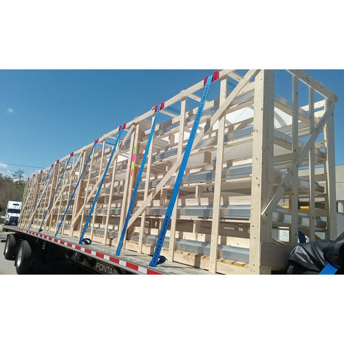 Large wood shipping crate containing Velux smoke vents strapped to a flatbed truck trailer