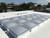 Grid array of low-profile Birdview double-dome skylights installed on a white commercial roof