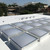 Grid array of low-profile Birdview double-dome skylights installed on a white commercial roof