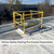 Closed ladder hatch with yellow safety railing installed on a white membrane roof