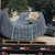 Curved welded wire mesh safety cage strapped to a flatbed trailer with a box of hardware, ready for shipping