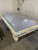 Clear polycarbonate dome skylight strapped inside a wood shipping crate with a barcode label, on a warehouse floor