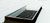 Sunoptics burglar bar screen installed over a skylight curb on a white membrane roof