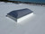 Sunoptics 4060 curb-mount dome skylight installed on a white commercial roof membrane, aerial close-up