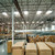 Distribution center interior with stacked boxes and conveyors lit by skylight daylighting