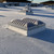 Sunoptics SVT2 smoke vent installed on a white membrane roof with palm trees and low buildings behind it