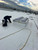 Technician installing a Sunoptics SVT2 smoke vent on a snow-dusted rooftop in winter