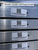 Close-up of Sunoptics skylight identification labels with QR codes affixed to the aluminum frame edge
