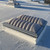 Close-up of the closed Sunoptics 4080 smoke vent's ribbed dome and aluminum curb frame on a white roof