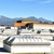 Rooftop photo of a domed smoke vent in the foreground with a mountain range and blue sky behind