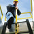 Low-angle shot of a worker descending a fixed ladder through a hatch, holding the yellow LU-1 post