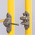 Close-up of the mounting bracket and latch hardware on the yellow Bil-Guard rail posts