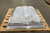 Velux dome skylight wrapped in plastic and strapped to a wooden pallet in a warehouse