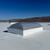 Velux CMD2 skylight installed on a white roof, wide shot with other skylights visible