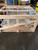 Velux shrink-out smoke vent dome and wire safety cage packed together in a wood shipping crate with fragile labels