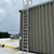 KattSafe RL30 ladder mounted on a ribbed metal wall, viewed from the roof with painted walk-pad markings below
