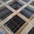 Top view into a wood shipping crate of nested Curbs Plus CPC-3 roof curbs with welded wire safety screens