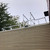 White aluminum KD001 ladder dock landing platform mounted at the edge of a roof above tan vinyl siding