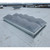 Faceted diamond-pattern smoke vent dome installed on a white membrane roof near industrial buildings