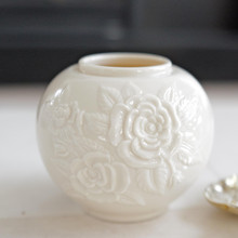 The luminous ivory porcelain emanates a soft, warm glow that complements both vibrant floral arrangements and minimalist décor schemes, its neutral palette ensuring timeless appeal across changing design trends.