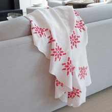 Vintage white linen tablecloth with red hand embroidered flowers.  The back shows the floral design has been hand cross stitched.  This would make a lovely addition to any holiday decor.