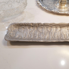 This elongated vintage aluminum tray by Arthur Court features charming elephant designs along both sides, creating a perfect blend of functional design and whimsical artistry for your entryway or console table.