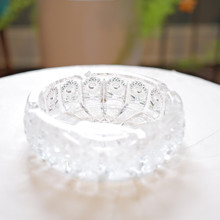 The mesmerizing geometric precision of this ashtray's cut pattern creates a hypnotic visual rhythm, drawing the eye inward toward its starburst center—a masterclass in traditional glassmaking techniques.