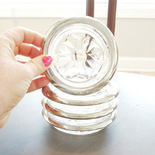 Stacked set of vintage silverplate and glass coasters with a close up on one coaster to show the Made in Italy stamp in the glass