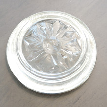 The back of a vintage silverplate rimmed glass coaster