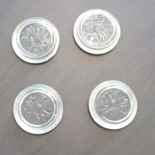 The back of a set of three Italian silverplated glass coasters