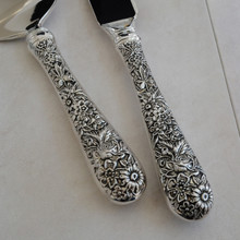 Vintage cake knife by Godinger .  Made with stainless steel blades and ornate silver plated handles.  This elegant piece have a high gloss shine.  An elegant wedding cake knife.