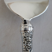 Vintage cake server by Godinger .  Made with ornate silverplated handles in a floral theme.