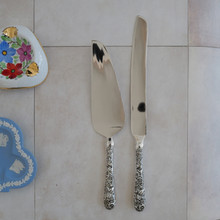 Vintage cake server by Godinger .  Made with stainless steel blades and ornate silver plated handles.  These elegant pieces have a high gloss shine.