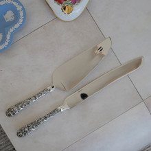 Vintage cake knife by Godinger .  Made with stainless steel blades and ornate silver plated handles.  These elegant pieces have a high gloss shine.