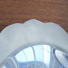 A beautifully crafted silver-plated tray, the Wallace Royal Rose 9807 features an ornate, raised floral border. Its classic oval shape and polished surface make it a versatile and elegant addition to any collection.