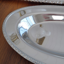 Designed for both elegance and practicality, this vintage MSG stainless steel serving tray is lightweight yet sturdy. The mirror-polished surface beautifully reflects light, adding a refined touch to any table setting.
