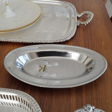 This vintage MSG stainless steel serving tray from Japan measures 12.5 inches long. With its sleek mirror finish and subtle embossed border, it’s perfect for serving appetizers, bread, or side dishes with a touch of elegance.