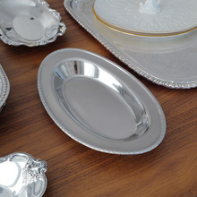 A true mid-century modern classic, this MSG Japan stainless steel tray showcases clean lines and a simple yet ornate border. Its resilient, tarnish-resistant material ensures it remains a stylish staple for years.