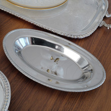 Crafted from high-quality stainless steel, this MSG Japan serving dish is both durable and stylish. Its polished surface and classic oval shape make it a timeless addition to any kitchen or dining collection.