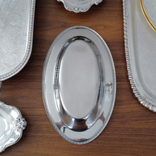 Timeless and elegant, this MSG stainless steel serving tray combines vintage charm with everyday functionality. The stainless steel construction ensures durability, while the decorative rim adds a touch of class.