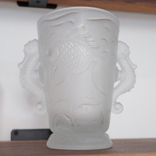 Notice the charming seahorse handles that flank the vase, their curled tails and textured bodies adding extra whimsy to this aquatic masterpiece.