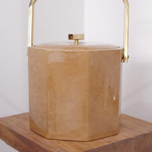 The caramel marbled vinyl and brass handle give this vintage ice bucket a clear 1970s vibe.