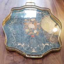 A timeless wooden tray with pierced brass gallery and handles, decorated with intricate floral marquetry and a blue-green-toned background.