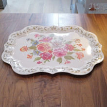 With its scalloped edges and gold detailing, this tray adds a touch of shabby chic elegance to any space.