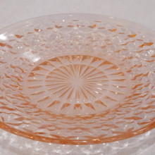 Features raised diamond texture with a radiant sunburst center.  Produced in soft pink glass that glows beautifully in light.