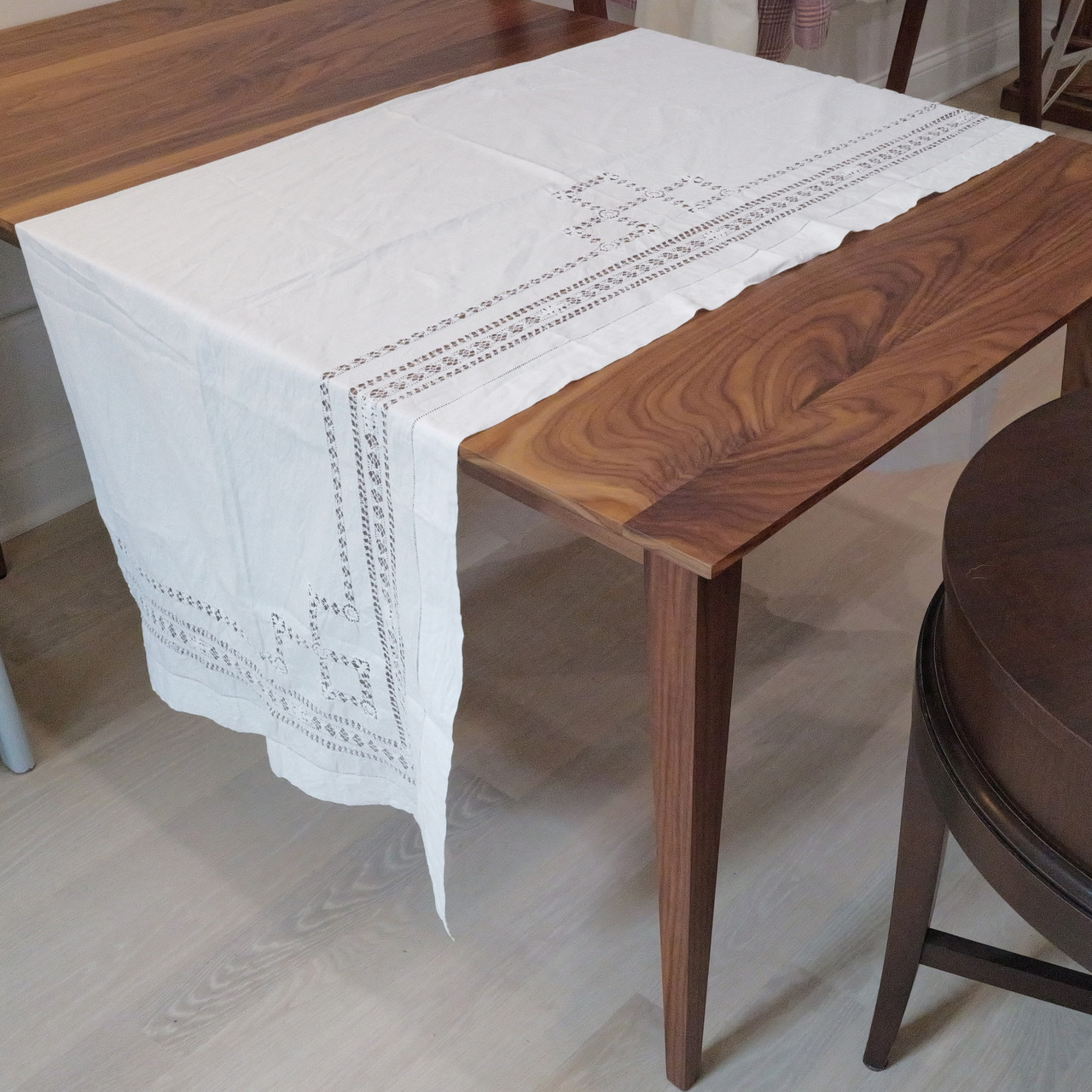 Vintage white table runner with delicate crochet lace trim.  Elegant and timeless, ideal for formal or casual settings.