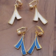Vintage clip on earrings feature bold geometric design with retro flair. Crafted in gold tone with glossy enamel accents.  Enamel colors include crisp white and vivid blue.