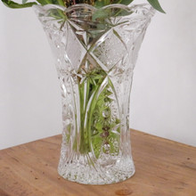 A sparkling vintage crystal vase that captures light from every angle.